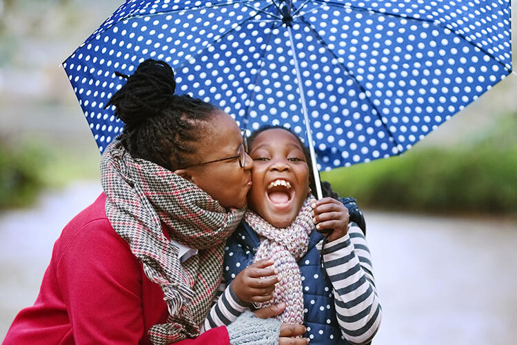 Mother and child under umbrella